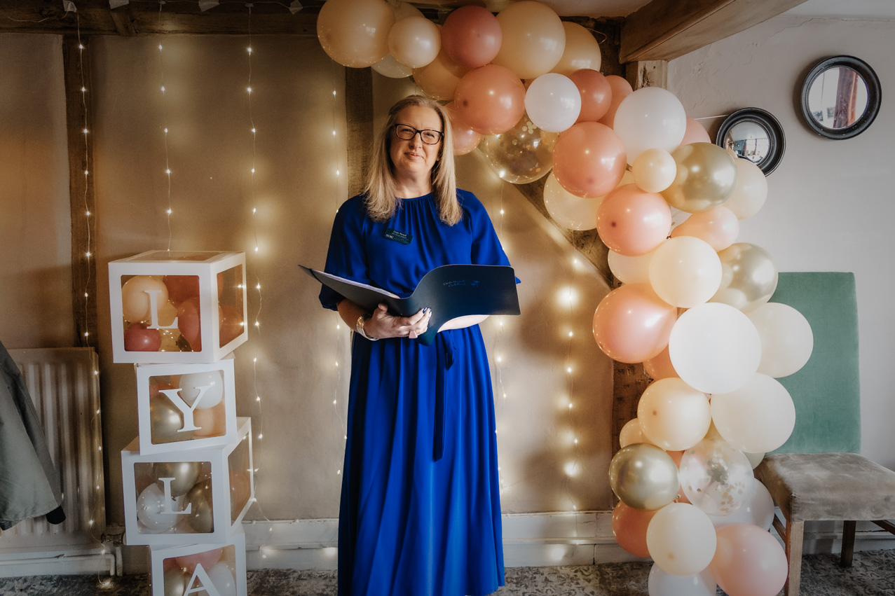 Deb Reed Celebrant Essex Colchester posing with arms out smiling.